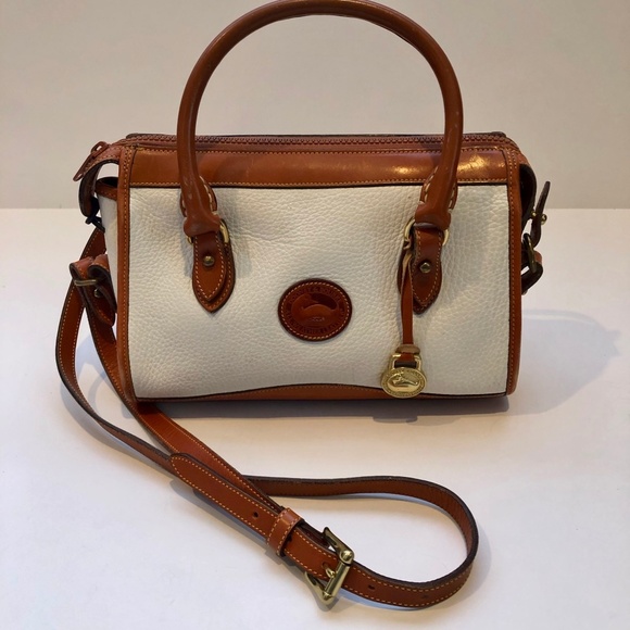 Recently found what I believe to be vintage Dooney and Bourke. It's a  satchel style that has to be at least 20-25 years old. Could any1 help me  identify the era 